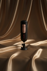 Erovia PDX Elite vibrating hands-free pleasure device with a black casing, flesh-toned sleeve, and suction cup base.